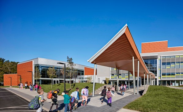 Canopy provides weather protection at the bus drop-off.
A spine of pavers draws students into the three story atrium.