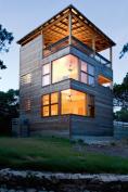 This simple sleeping volume offers great views and warm veneer-lined interiors. The architects clad the building in extremely durable massaranduba tropical wood.