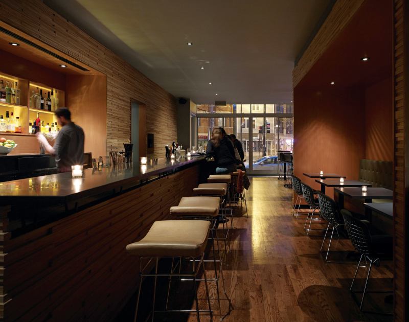 The new Tiny Lounge packs a lot into a 2,000-square-foot package. Several distinct table-seating areas (high-top tables, banquet seating, and booths) maintain an intimate feeling, while floor-to-ceiling glass doors capture as much daylight as possible for the after-work crowd.