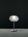 The Soffione table lamps from Artemide provide diffused halogen lighting. The diffuser, designed to recall the geometric structure of crystals, is made of white, handblown glass with a polished silk finish. The base is die-cast aluminum with a steel stem and is available in polished black or polished chrome. A dimmer switch is located on the cord. Two versions of the lamp are available: the first measures 22-3/16" tall and 9-1/16" wide and takes a 150W bulb; the second is 28-3/4" tall and 10-3/4" wide and takes a 250W bulb. Soffione was designed by Michele De Lucchi. artemide.us