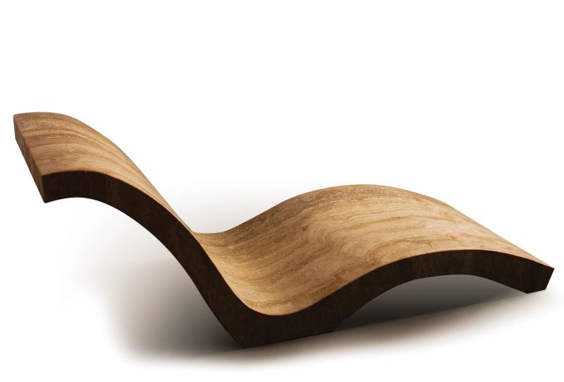 Chaise by Stone Forest is carved from one piece of silver-gray Italian marble. The piece of lawn furniture features web-like inclusions that run against the horizontal veining inherent in the stone. When used indoors, it absorbs ambient room temperature, and when outdoors absorbs the warmth of the sun without becoming too hot. Available in Silver Travertine and Travertino Romano, the lounge measures 26" wide by 63" long by 22" tall and weighs 700 pounds. stoneforest.com
