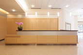 Reception desk and wall accents in ViviChrome Chromis glass with Taupe interlayer and Opalex finish at Lloyd Center Tower, Portland, Oregon
