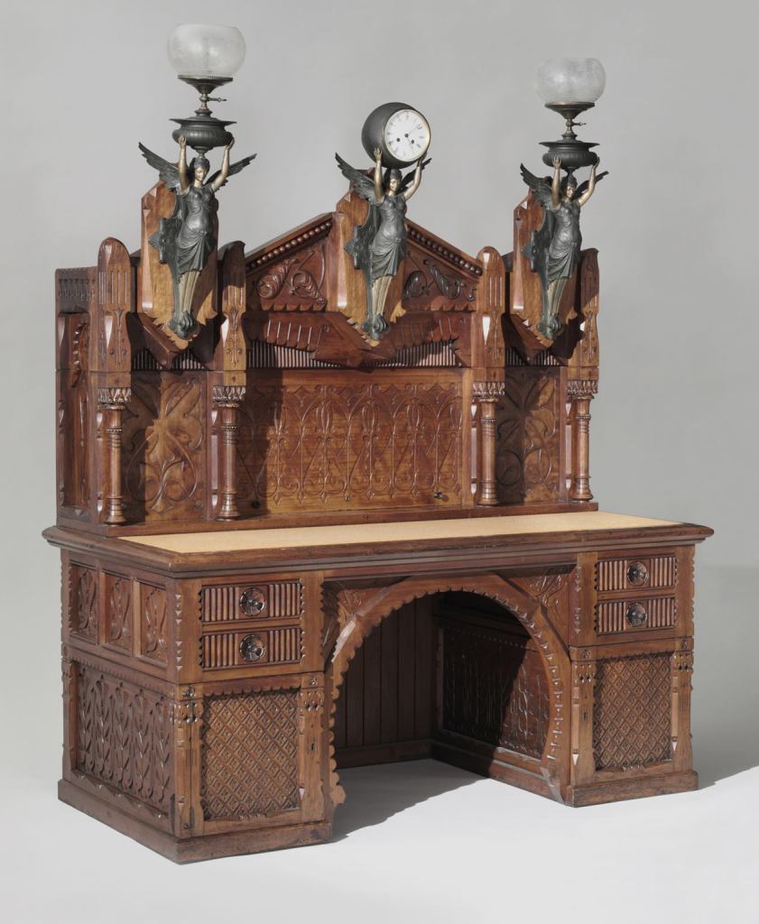 Desk, designed by Frank Furness, American, 1839-1912. Possibly made by Daniel Pabst, American (born Germany), 1827-1910. Philadelphia, c. 1875, Walnut, white pine, maple, poplar, with clock and lamp mounts and glass globes. Made in Philadelphia; gift of George Wood Furness, 1974.
