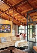 Open to the adjacent dining area, the room is separated from the living area by only a bank of storage cabinets.