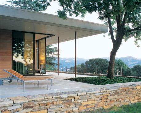 Sliding glass doors open up the corner of the master bedroom to views of the vineyard and mountains beyond. Ample terraces establish a close connection between house and site.
