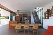 With upper cabinets limited to a single end wall, the kitchen opens to light and views along its two outside walls.