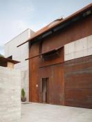 The entry facade is clad in Cor-Ten steel.