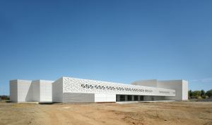 Polygonal perforations, abstracted from the building’s hexagon-based design, cascade across the exterior of the Contemporary Art Center in Córdoba, Spain, allowing natural light to dapple its interior.