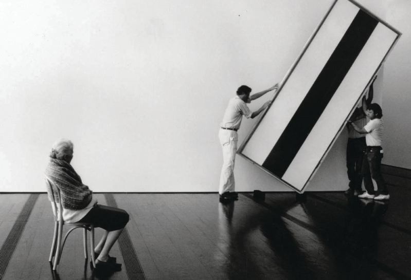 Dominique de Menil oversees workers as they hang a painting by Barnett Newman in the Menil Collection museum.