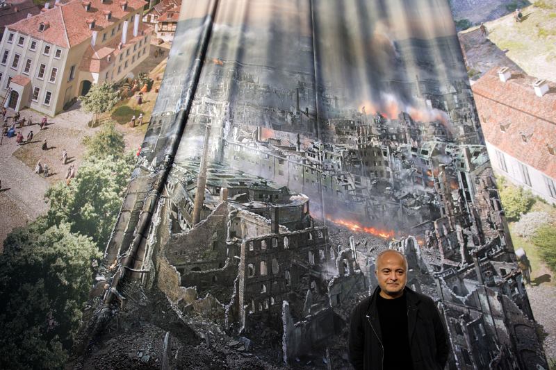 Artist Yadegar Asisi with a test print of the panorama "Dresden 1945 – Tragedy and Hope of a European City," which depicts Dresden, Germany, after the city was bombed in Feb. 1945. The installation is from the perspective of the town hall tower. The panorama goes on display at the city's Panometer on Jan. 24.