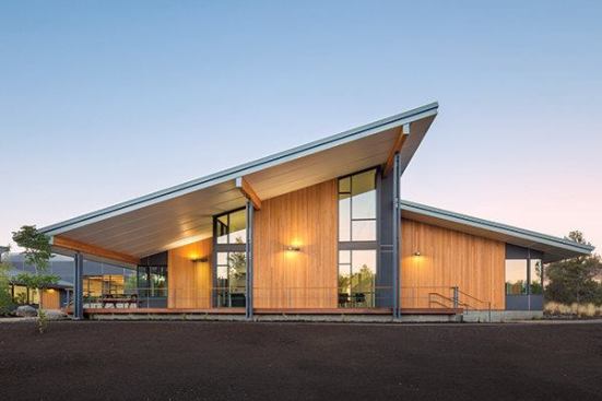 Panels of hemlock ribs accent the walls in the school entrance. The play of light among a line of trees in a black-and-white photo of a nearby canyon inspired the abstract pattern. “We sketched out a lot of concepts for the entry,” Eddy says. “In the end, everyone was most comfortable with a surface treatment that remained in character with the rest of the building.”