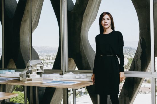 Jennifer Marmon stands beside a section model for PAR’s Helsinki Central Library proposal. The firm collaborated with Arup on a highly technical, transparent façade with thermal properties.