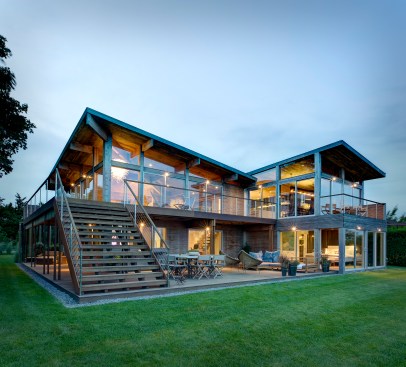 The 1970s home—once enclosed and introspective—now opens out to embrace the view with plenty of glazing and outdoor living space.