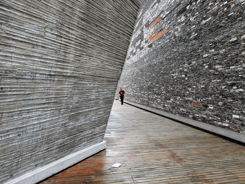 Amateur Architecture Studio's 2008&nbsp;Ningbo Historic Museum features a bamboo-formed concrete wall (left) as well as wapan masonry construction (right).