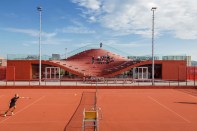 The southern fa&ccedil;ade, which features seating that overlooks the clay tennis courts.