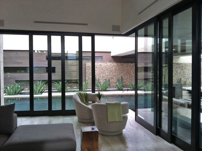 90° Corner Pocketing Multi-Slide doors open from the corner and slide into the wall to transition between indoor and outdoor living spaces. The doors use aluminum-clad or wood exteriors and all wood interiors, with various finish options available. www.sierrapacificwindows.com. Circle No. 41.