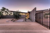 Front entry of home.  The low point of the butterfly roof is centered over the front entry door.  An 
exposed beam connects the roof and creates an organizing element inside and outside the home.  This 
exposed beam defines the interior circulation path of home.