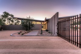 Front entry of home.  The low point of the butterfly roof is centered over the front entry door.  An 
exposed beam connects the roof and creates an organizing element inside and outside the home.  This 
exposed beam defines the interior circulation path of home.