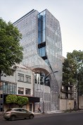 A cutaway in the skin creates an arch for a second-story terrace at Profiles' southeast corner.