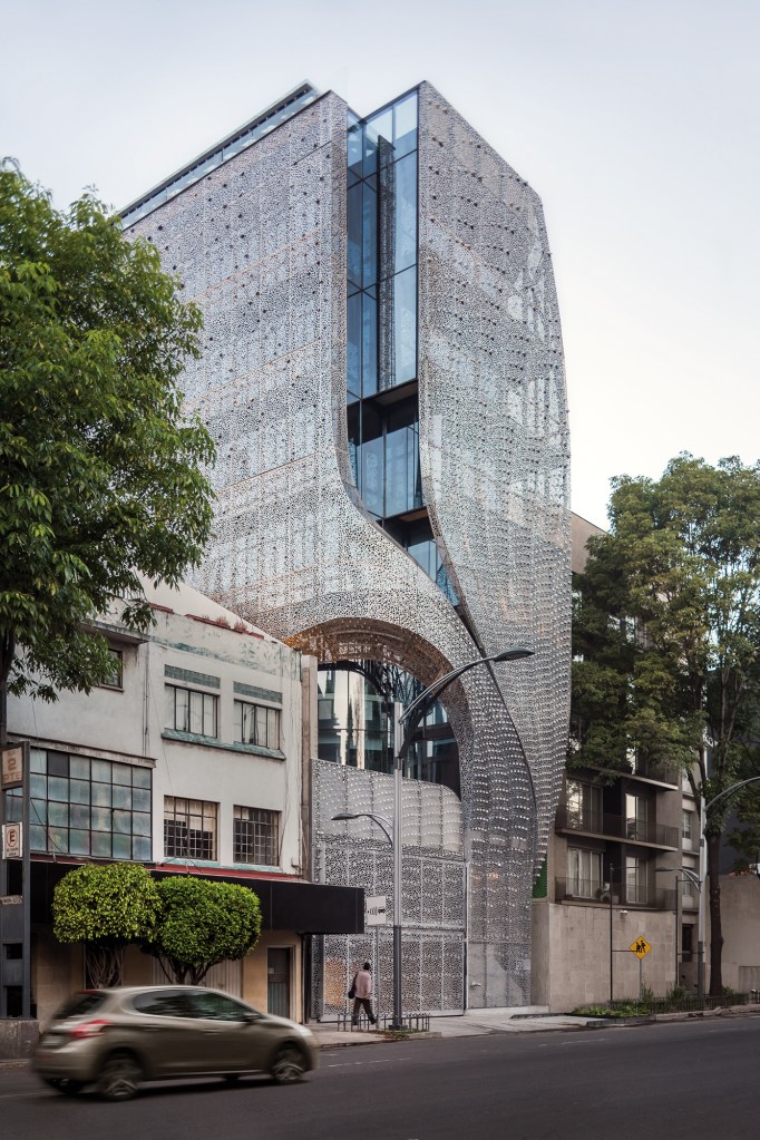 A cutaway in the skin creates an arch for a second-story terrace at Profiles' southeast corner.