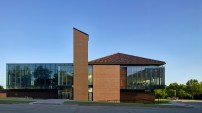 The north elevation illustrates the intersection of the dual facades as the traditional masonry and clay tile roof on the west begins to transition to zinc cladding and glass on the east.