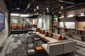The lower lounge flows into a more casual seating area with a galley, fitness center, a work lounge, and conference center.