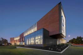 A back-lit, frosted glass portal engages traffic and serves as a billboard for the campus.