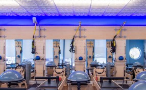 A chain of Club Pilates exercise studios in Southern California have created a signature décor built around a
Ceilume decorative thermoformed ceiling with a blue glow lighting up the edge.