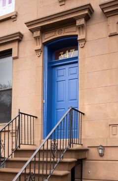 Front entrance with custom LPC-compliant pre-war door. 