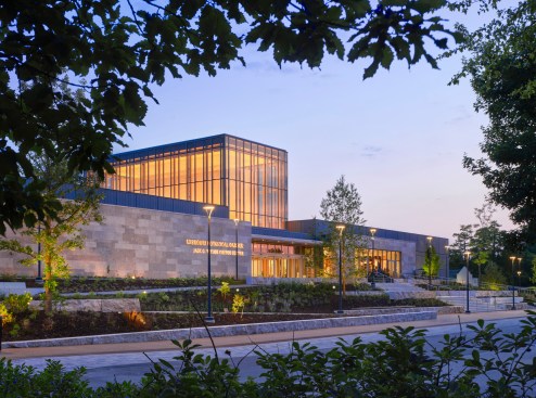 The exterior of the Jack C. Visitor Center front entrance and gardens at dusk
