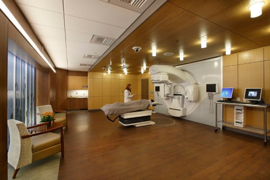 In the radiation treatment suite, patients are enveloped in warm wooden materials from floor to ceiling. A glass architectural sculpture entitled, "Behind the Waterfall" alludes to life after cancer and provides a grounding focal point.