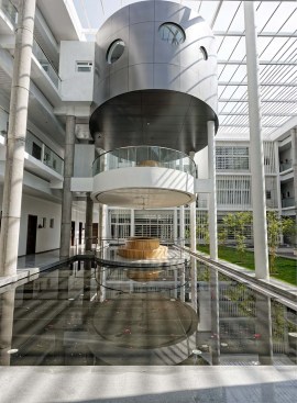 A semi open waiting area & a conference above  connecting the passages at different levels is a part of the courtyard & the waterbody. It forms the focal point of the building with its distinct identity overall through its shape . 
