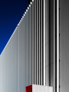 White aluminum lines vary in width as they move from one edge to the other.  
