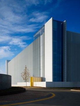 The northeast corner form connects to the building across the street. The white lattice opens and closes as you move past.