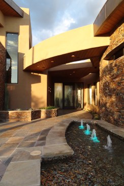 FRONT ENTRY
Dramatic Entry welcomes guests with stacked stone accents, curved overhangs and a rock-lined water feature.
