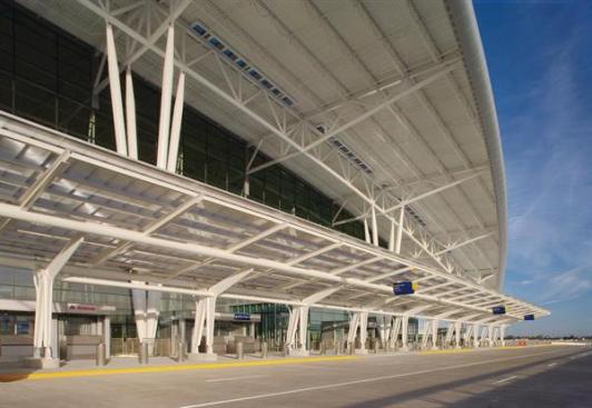 The design firm worked with Josef Gartner GmbH on the production of the glass curtain wall that encloses the ticket hall and baggage claim area on the two-story building. The system works to allow natural light into the building, while shading from a roof overhang helps to reduce glare and heat gain.  Curtain wall Kawneer North America Aluminum storefront 451 curtain wall kawneer.com  Roofing Wheeling Corrugating Co. Metal decking wheelingcorrugating.com  Lighting Architectural Area Lighting Roof overhang lighting aal.net
