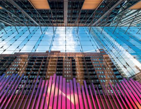 Glass-Fin Wall and 150 Media Stream - The 150 Media Stream addresses the transition between the opaque wall over the parking deck and the glass-fin wall above.