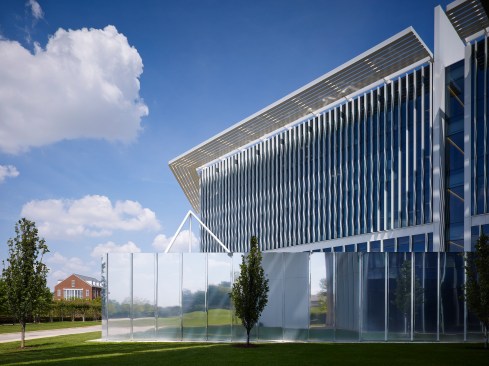 The west elevation illustrates the roof edge sunscreen, glazing vertical fins and the polished stainless steel mechanical enclosure


