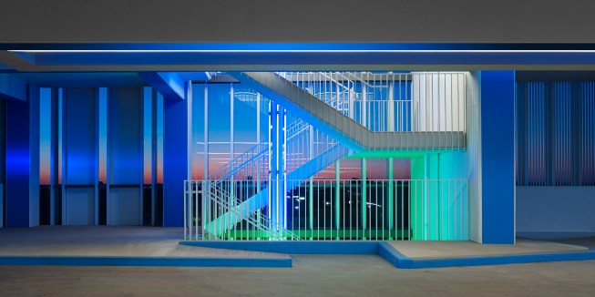 13  One of four stairways within the building.  Colored light identifies the floor level beginning at the stair and continues into the parking level.  The exterior glass provides a wind break.   