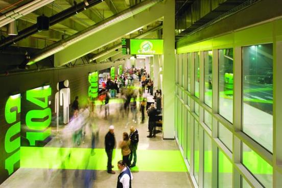 Kent Event Center The vivid green lines that start in the parking lot continue through the lobby and the gates to the different sections of the hockey arena. The industrial space?with polished concrete floors and black-painted cinder block walls?is enlivened by supergraphics. Large green numbers mark each door, and large white stylized figures indicate the restrooms.
