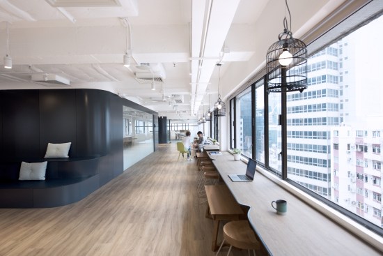 The heart of the workplace includes a collaborative bar island, stage seating, and a long signature “Bean” Table 