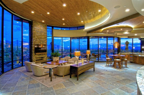 GREAT ROOM
Expansive Great Room’s curved window walls provide magnificent views outside, exquisitely curved ceiling soffitry, with alder wood accents, helps define activity areas, and Travertine tile flooring provides a consistent base from outside to inside.
