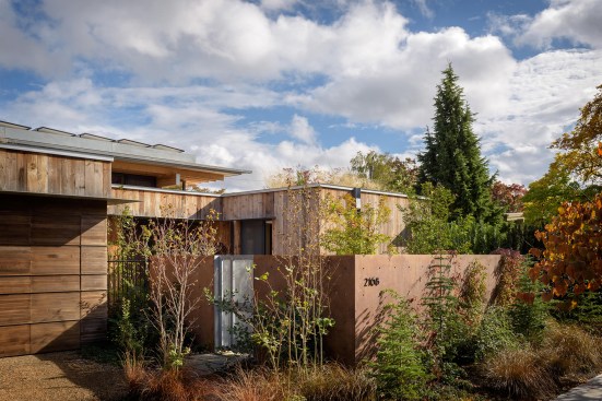 A gated wall surrounds the infill site, creating the client’s urban oasis.