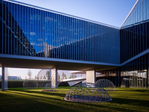 The central open courtyard is a result of the 60’ foot building module for light penetration in the building.  The open dome forms suggest natural gas bubbling on the surface.
