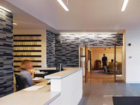 The reception area serves as the main point of entry, not only to the operations and laboratory area, but also to the education area, which is the part of the program most accessible to the public. Visitors enter into a space lined with Heath Ceramics tile, another local resource, and can proceed to conference rooms and other areas beyond