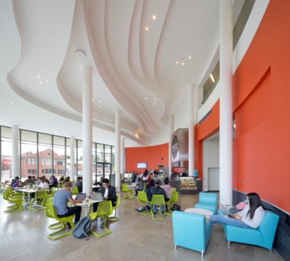 The cafe with sculpted ceiling beneath 'floating' lecture hall in double-drum structure.