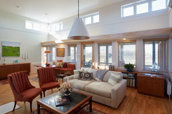 Mid-Century Mod on the Prairie - Living Room

This open-space living and dining room illustrate the ideal of Vastu living, where natural light and fresh air come into the house from many directions. 