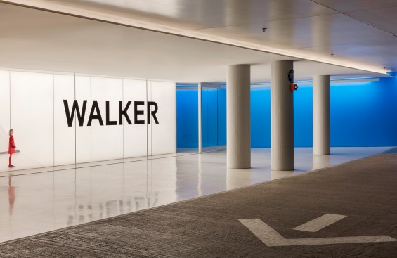 The bold blue of the new garage entrance recalls the vivid yellow vestibule at street level.