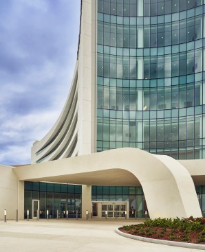 The entrance features a swooping concrete canopy
