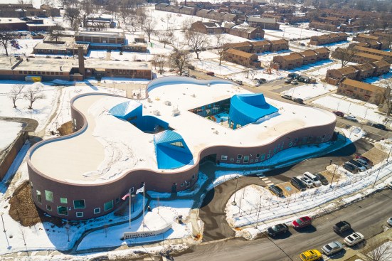 The center features an interior outdoor playground and two brightly colored light monitors on the roof.